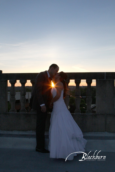Franklin Plaza Wedding Photo Bride and Groom silhouette kissing with sunflare on rooftop of Franklin Plaza NY