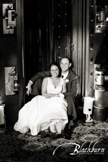 Upstate NY Wedding Photographer Newlyweds seated in bank vault of Franklin Plaza NY